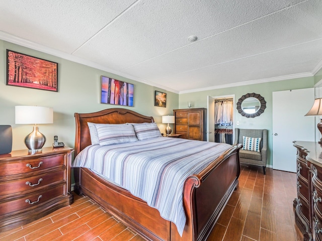 bedroom with crown molding, wood tiled floor, and a textured ceiling