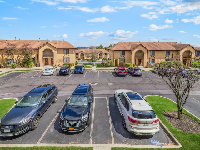 uncovered parking lot featuring a residential view