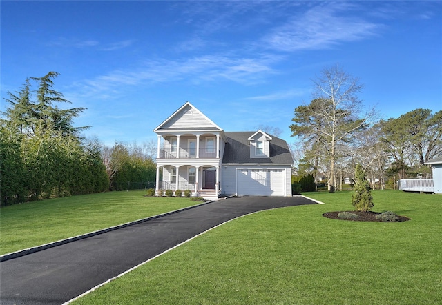 view of front of property with aphalt driveway, a balcony, a front lawn, a shingled roof, and a porch
