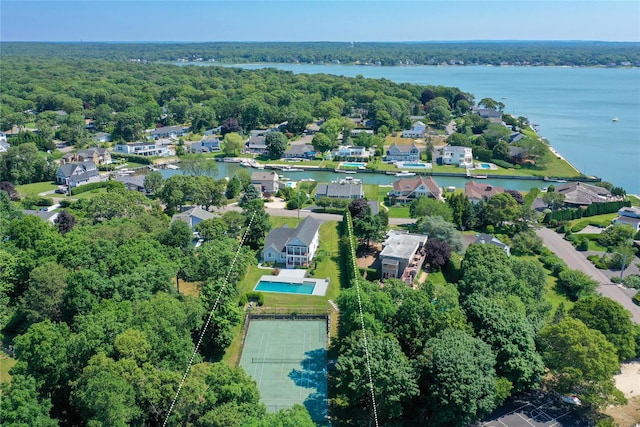 bird's eye view with a water view and a wooded view