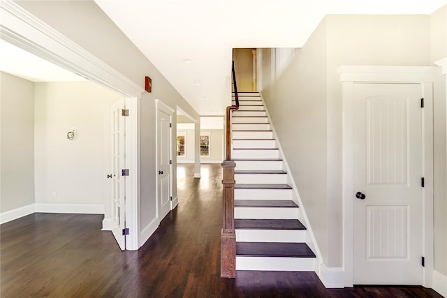 stairs featuring baseboards and wood finished floors