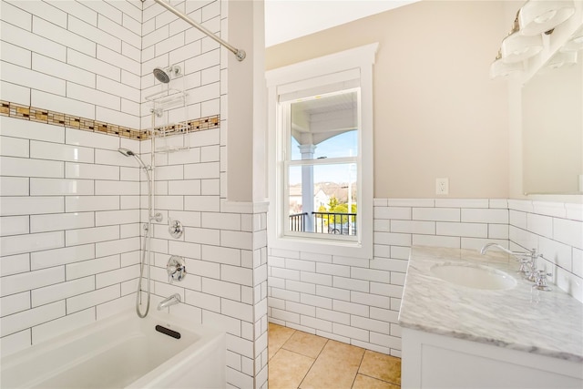 full bathroom with tile walls, tub / shower combination, tile patterned floors, vanity, and wainscoting
