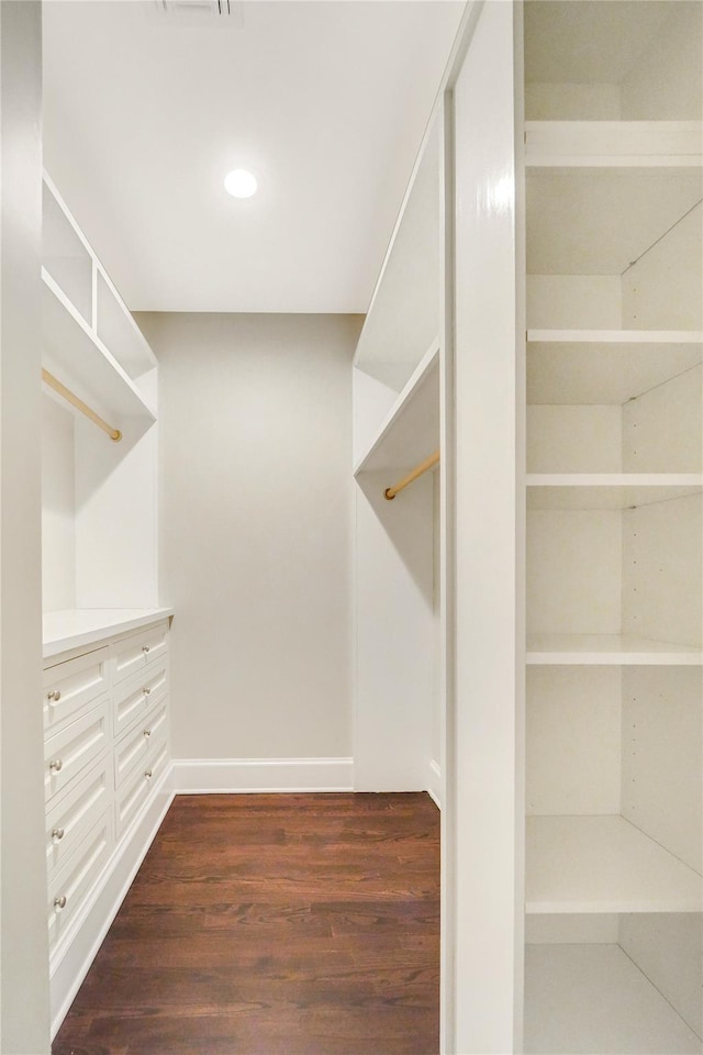 walk in closet featuring dark wood-style floors and visible vents