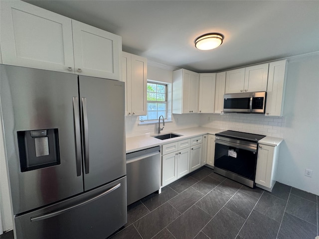 kitchen featuring light countertops, a sink, white cabinets, and stainless steel appliances