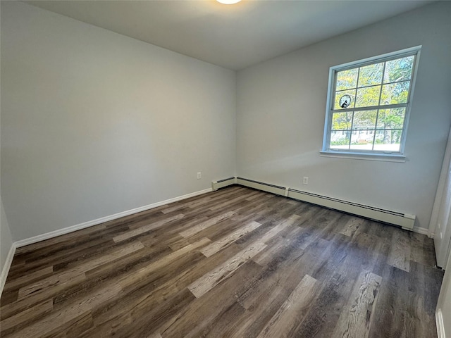 unfurnished room featuring dark wood-type flooring, baseboards, and baseboard heating