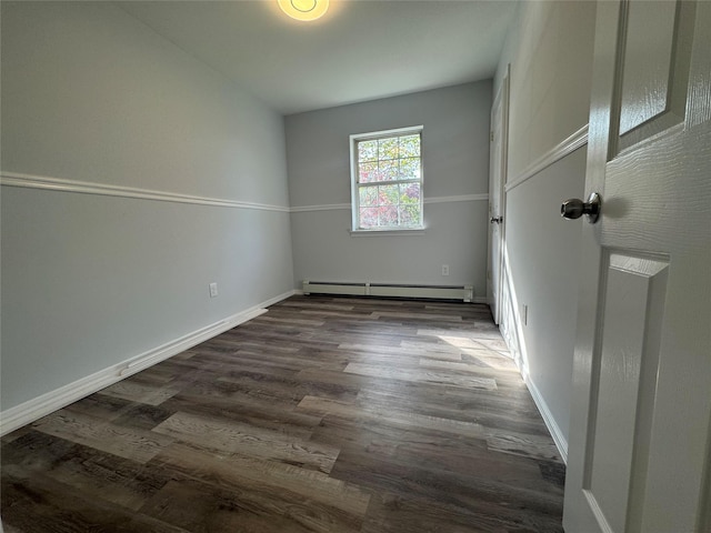 unfurnished room featuring baseboards, dark wood-style flooring, and baseboard heating