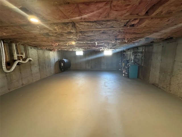 below grade area with a heating unit and heating fuel