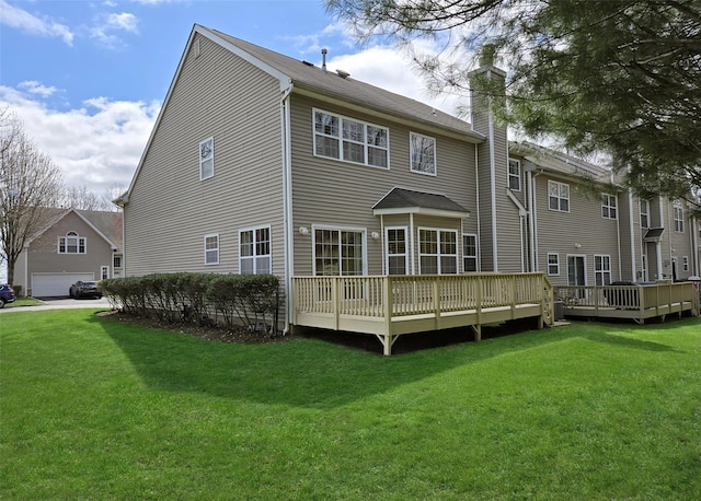 11 Arielle Ct, Islandia, NY 11749 - rear view of property featuring a yard, a chimney, and a deck