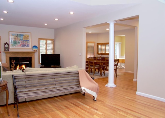 11 Arielle Ct, Islandia, NY 11749 - interior space featuring baseboards, a lit fireplace, light wood-style floors, and recessed lighting