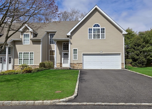 11 Arielle Ct, Islandia, NY 11749 - view of front of house featuring stone siding, aphalt driveway, a front yard, and a garage