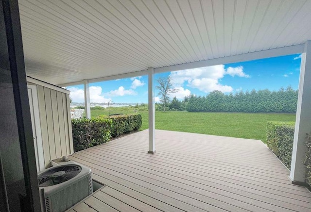 61 W Tiana Rd Unit 3, Hampton Bays, NY 11946 - deck featuring a storage unit, a lawn, an outdoor structure, and central AC