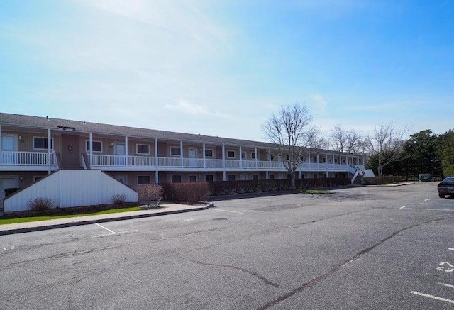 61 W Tiana Rd Unit 3, Hampton Bays, NY 11946 - view of building exterior featuring uncovered parking