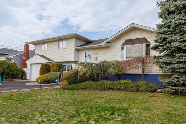 tri-level home with a front yard