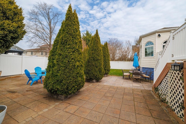 view of patio with a fenced backyard and outdoor dining space