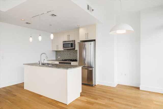 412 Kings Hwy Unit 6C, Brooklyn, NY 11223 - kitchen with a sink, stainless steel appliances, decorative backsplash, baseboards, and light wood-style flooring
