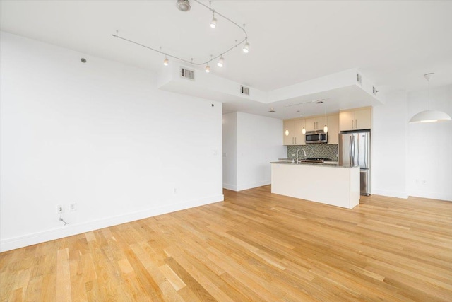 412 Kings Hwy Unit 6C, Brooklyn, NY 11223 - unfurnished living room with arched walkways, light wood-style floors, and baseboards