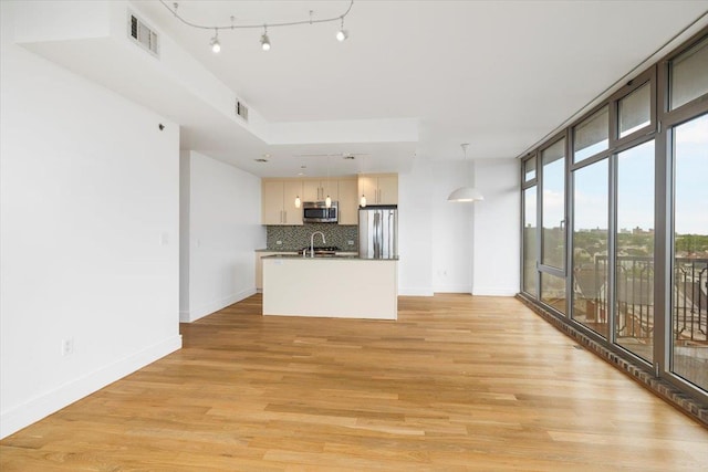 412 Kings Hwy Unit 6C, Brooklyn, NY 11223 - unfurnished living room with baseboards, light wood-type flooring, and expansive windows