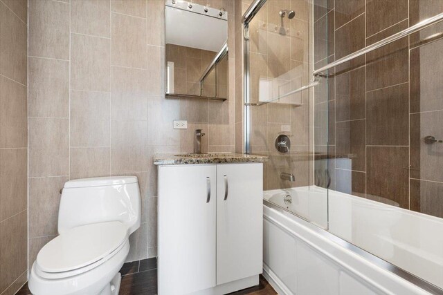 412 Kings Hwy Unit 6C, Brooklyn, NY 11223 - full bath featuring tile walls, vanity, enclosed tub / shower combo, and toilet