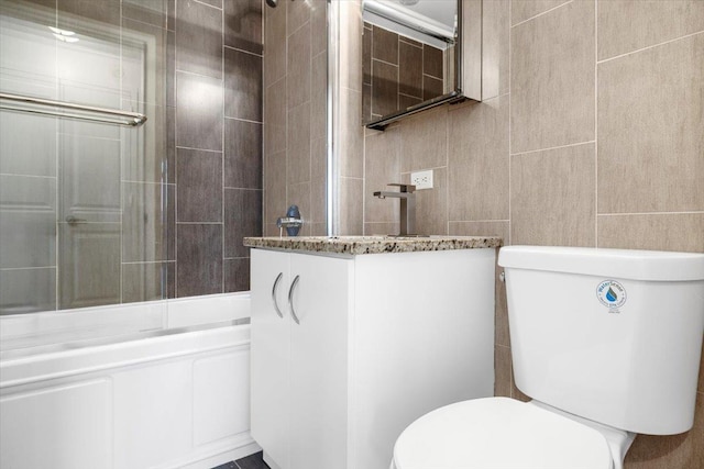 412 Kings Hwy Unit 6C, Brooklyn, NY 11223 - bathroom with tile walls, toilet, vanity, and bathing tub / shower combination