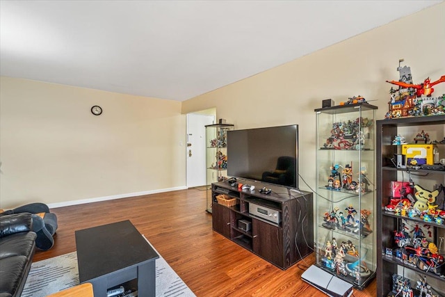 living room with wood finished floors and baseboards