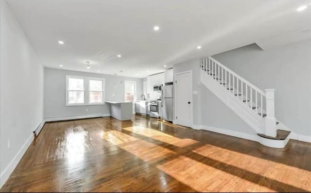 unfurnished living room with baseboards, recessed lighting, stairway, and dark wood finished floors