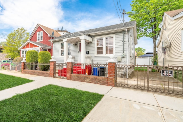 bungalow featuring a gate and a fenced front yard