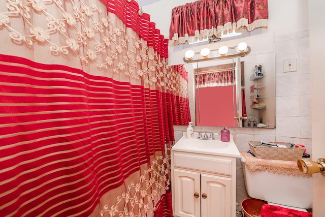 bathroom featuring tile walls and vanity
