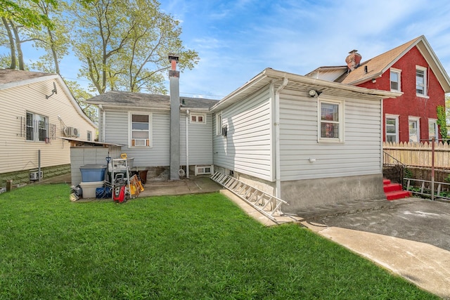 back of house with a lawn, a patio area, and fence