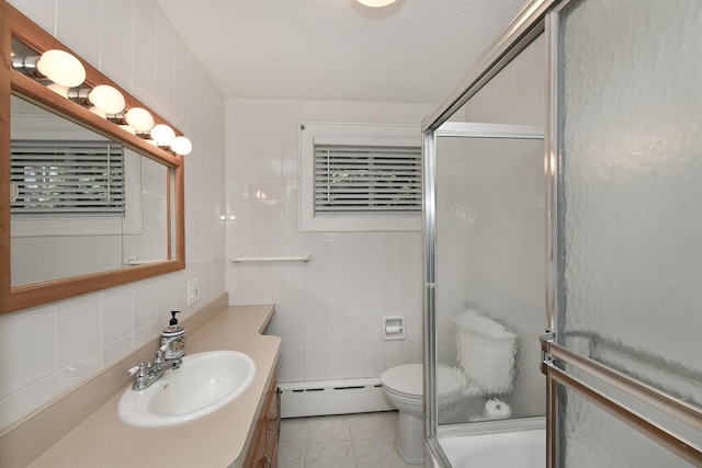 full bathroom with tile patterned flooring, an enclosed shower, a baseboard radiator, and tile walls