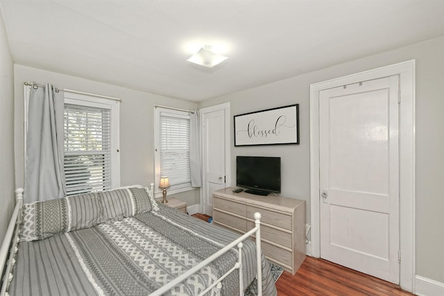 bedroom with dark wood-type flooring