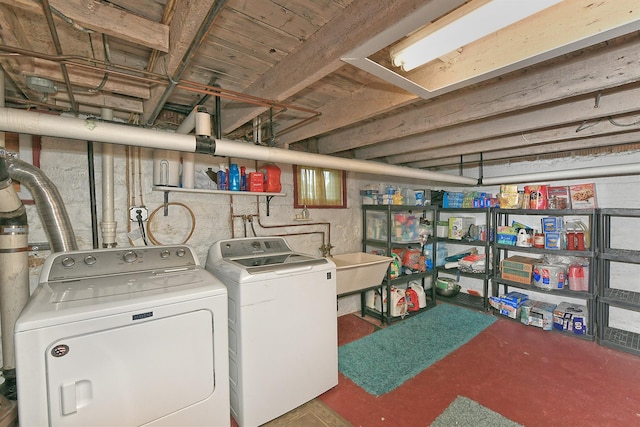 laundry room with a sink, independent washer and dryer, and laundry area