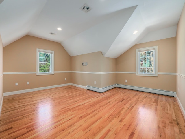 bonus room with visible vents, light wood-type flooring, and vaulted ceiling