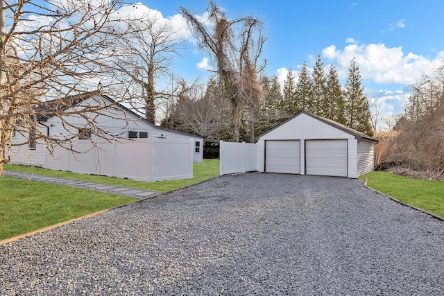 detached garage featuring fence