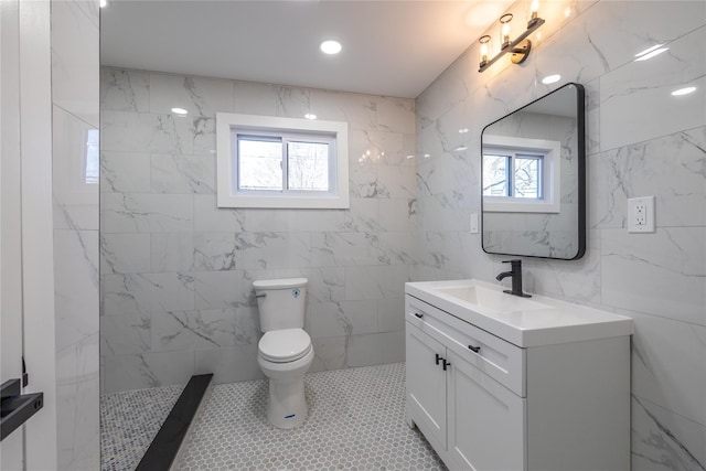 full bath featuring tile walls, toilet, a tile shower, and vanity