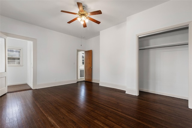 unfurnished bedroom with baseboards, ceiling fan, a closet, and dark wood-style flooring