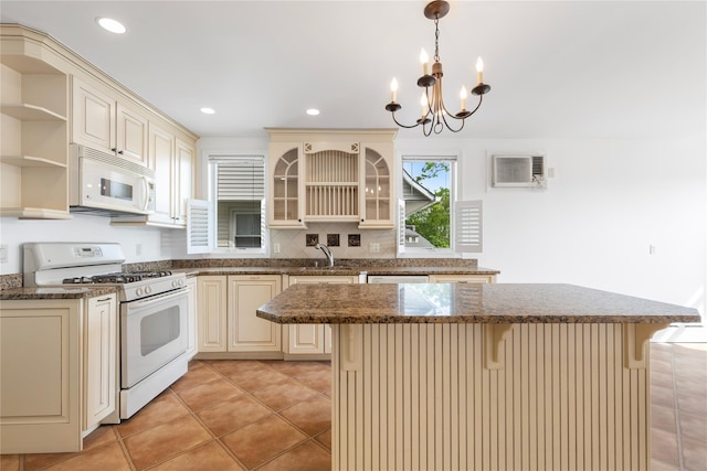 kitchen featuring cream cabinets, open shelves, a sink, and white appliances