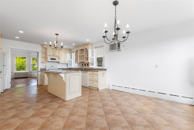 kitchen with open shelves, white appliances, radiator heating unit, cream cabinetry, and a chandelier
