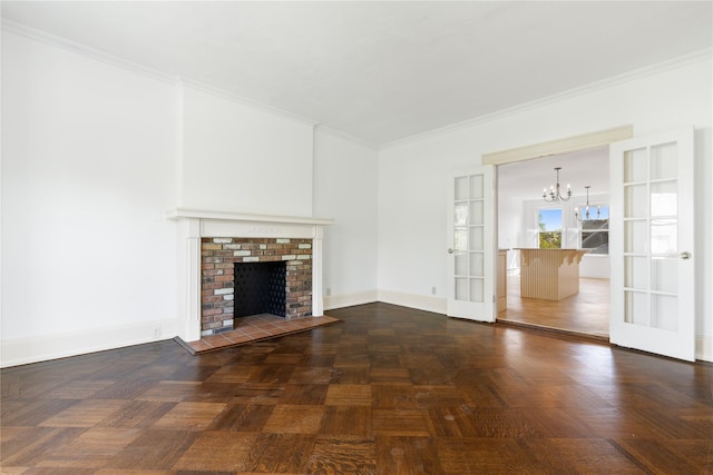 unfurnished living room featuring french doors, a fireplace, baseboards, a chandelier, and ornamental molding