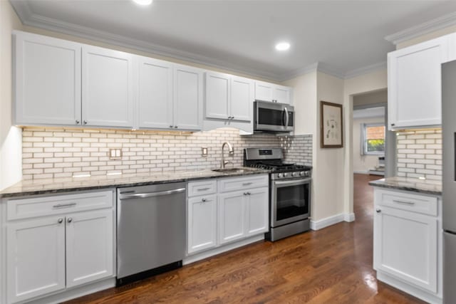 129 Parkside Dr, Suffern, NY 10901 - kitchen with appliances with stainless steel finishes, a sink, stone countertops, crown molding, and white cabinets