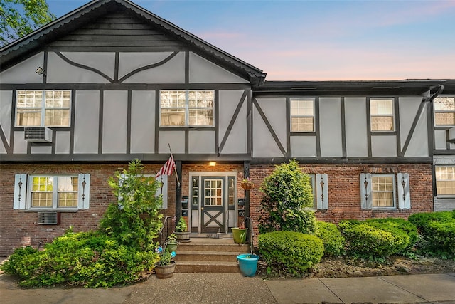 129 Parkside Dr, Suffern, NY 10901 - view of front facade featuring brick siding, stucco siding, and cooling unit