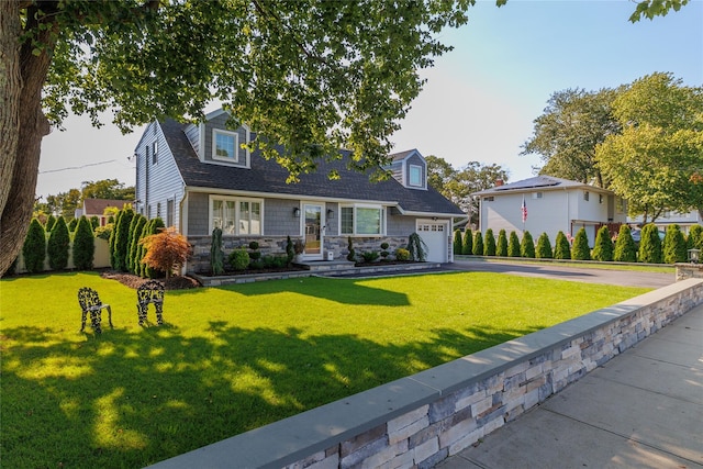 645 Hawkins Blvd, Copiague, NY 11726 - cape cod house featuring an attached garage, stone siding, driveway, a front yard, and a shingled roof