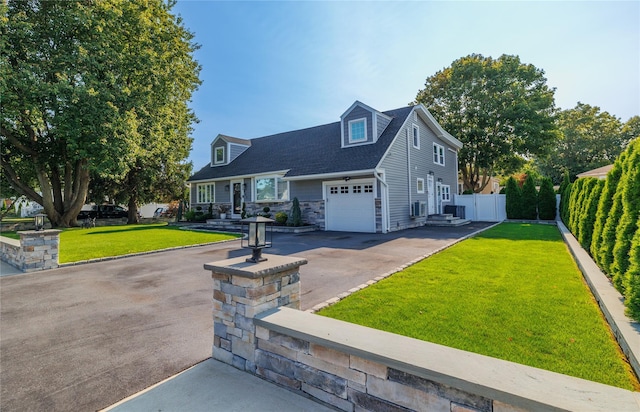 645 Hawkins Blvd, Copiague, NY 11726 - new england style home featuring fence, stone siding, aphalt driveway, a front yard, and a shingled roof