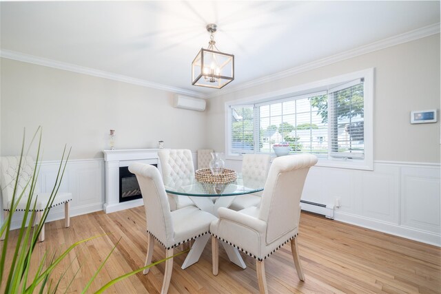 645 Hawkins Blvd, Copiague, NY 11726 - dining room featuring a wall mounted AC, crown molding, a wainscoted wall, and light wood-type flooring