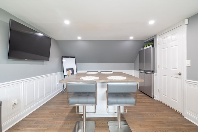 645 Hawkins Blvd, Copiague, NY 11726 - dining area featuring a wainscoted wall, lofted ceiling, wood finished floors, and recessed lighting