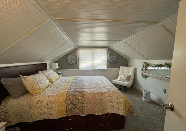12 Bluebird Dr, Lake Luzerne, NY 12846 - carpeted bedroom featuring vaulted ceiling and baseboards