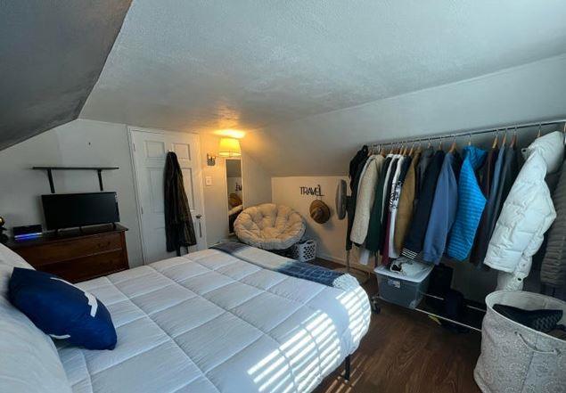 12 Bluebird Dr, Lake Luzerne, NY 12846 - bedroom featuring lofted ceiling, wood finished floors, and a textured ceiling
