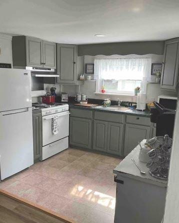 12 Bluebird Dr, Lake Luzerne, NY 12846 - kitchen with white appliances, gray cabinetry, and extractor fan