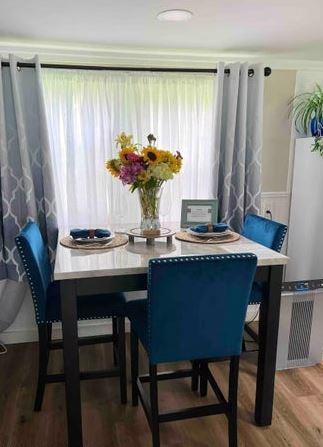 12 Bluebird Dr, Lake Luzerne, NY 12846 - dining area featuring wood finished floors and plenty of natural light