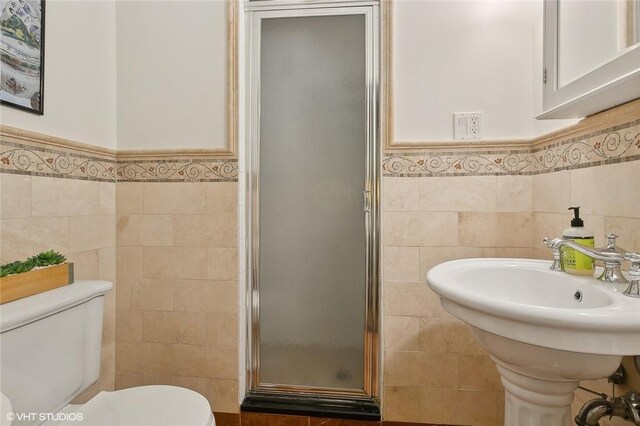 30 Appleton Pl, Dobbs Ferry, NY 10522 - bathroom with tile walls, a shower stall, toilet, and a wainscoted wall