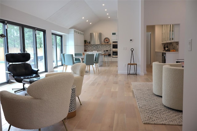 10 Hampton St, Westhampton Beach, NY 11978 - living room with recessed lighting, light wood finished floors, beverage cooler, and high vaulted ceiling